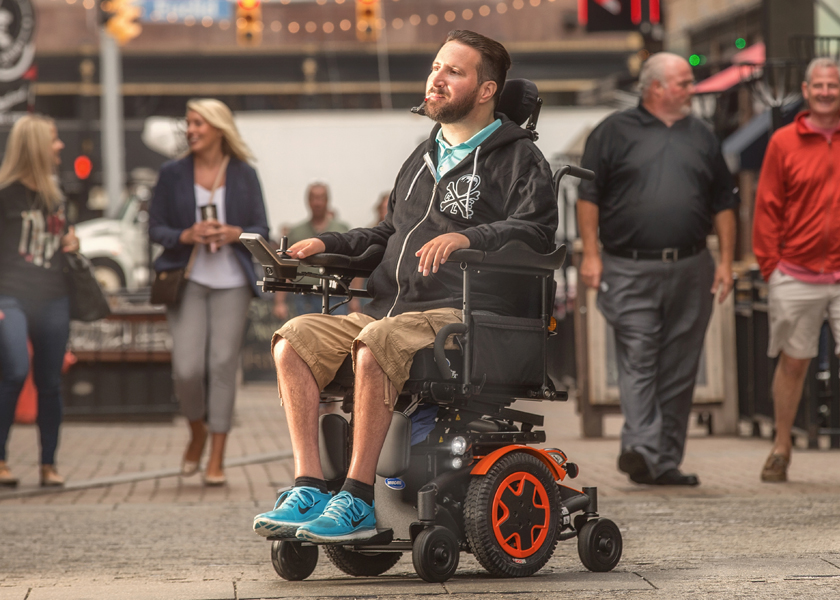 A man uses sip 'n puff controls to drive his TDX SP2 power chair