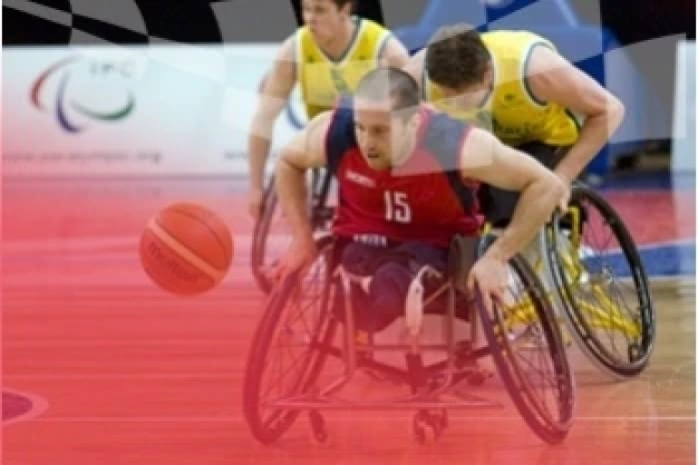 Several pro wheelchair basketball players are shown in action on a basketball court.