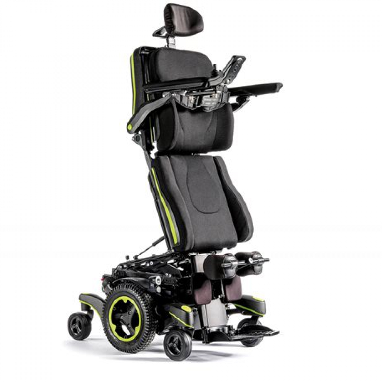 The Q700-UP standing wheelchair in the standing position with bright green trim