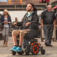 A man uses sip 'n puff controls to drive his TDX SP2 power chair thumbnail